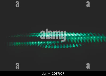 Blur neon defocused illuminated triangles. Noise dark abstract art background. Overlay texture