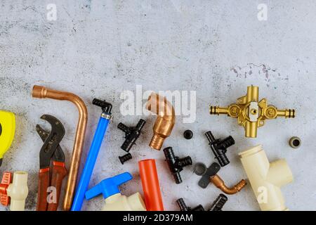 Necessary set tools for plumbers were prepared by craftsman, pipe fittings on a home improvement plumbing materials Stock Photo