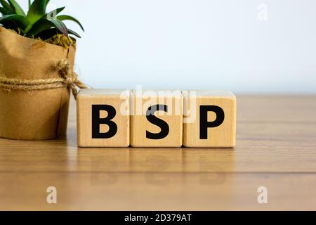 Concept word 'BSP - basic state pension' on cubes on a beautiful wooden table. White background. Business concept. Copy space. Stock Photo