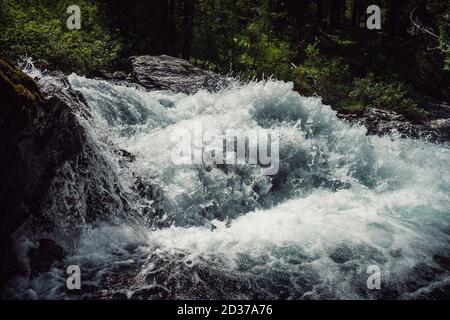 Big rapids of powerful mountain river. Beautiful background with azure water in fast river. Frozen motion of tall mountain river rapids. Power majesti Stock Photo