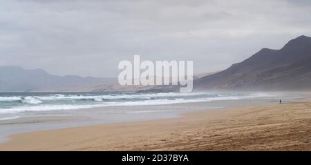Waves rolling onto a sandy beach at Playa de Cofete, Fuerteventura Stock Photo