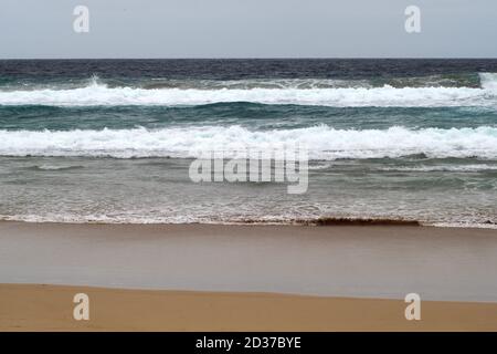 Waves rolling onto the beach Stock Photo