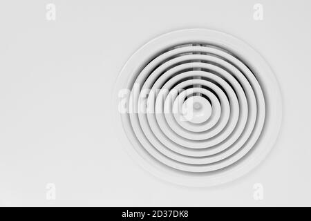 Round ventilation diffuser mounted in white ceiling, close-up photo Stock Photo