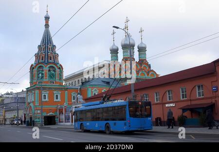 January 18, 2020 Moscow, Russia. The blue trolley bus on the background of the Church of St. Gregory neokesariysky in Darvizeh on Polyanka street in M Stock Photo