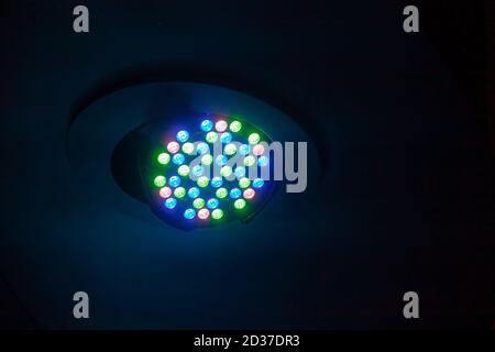 Colorful LED spot light mounted in ceiling of a night club, modern stage illumination equipment Stock Photo