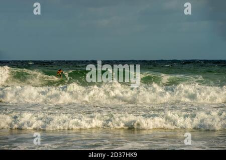 Surfers at Kealia beach which is Kapaa's premier surfing beach on Kauai Island, Hawaii, USA. Stock Photo