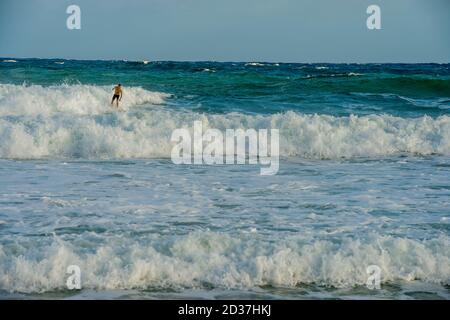 Surfers at Kealia beach which is Kapaa's premier surfing beach on Kauai Island, Hawaii, USA. Stock Photo