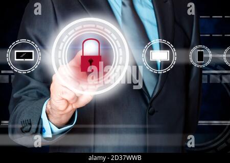 Businessman pressing security button on virtual screen. Business, technology and internet concept Stock Photo