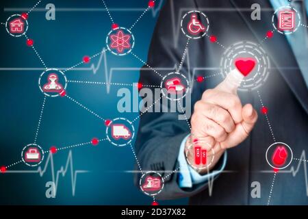 Businessman pressing a heart on a virtual screen. Health concept Stock Photo