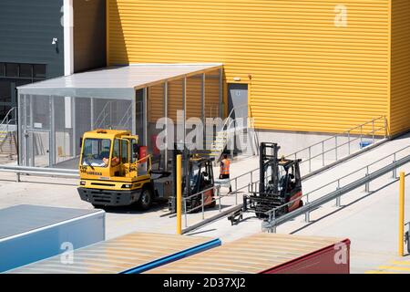 Shunter and forklift truck at a loading bay Stock Photo