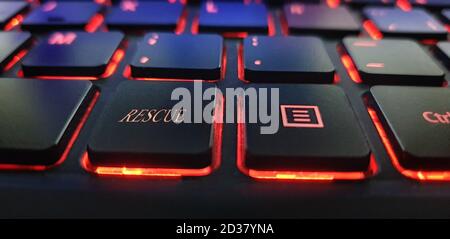 Black keyboard with red light and rescue text Stock Photo