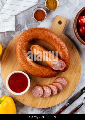 fresh homemade sausage on a light background with vegetables Stock Photo
