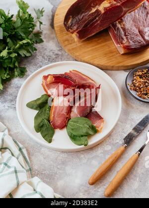 pastrami sliced on a plate with herbs Stock Photo