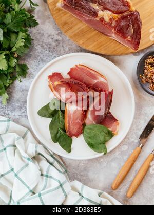 pastrami sliced on a plate with herbs Stock Photo