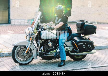 biker posing with on his custom motorcycle Stock Photo