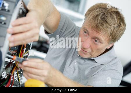portrait of an electronic engineer fixing pc Stock Photo