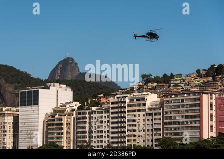 Helicopter Flying Above the Favela in Rio de Janeiro City Stock Photo