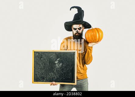 Vampire man on Halloween night - full length. Celebrate Halloween in America. Scary Halloween man in hat - studio shot close-up. Halloween poster or Stock Photo