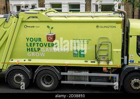 Recycling truck with slogan on side encouraging people to recycle food and green waste to make compost - Your Leftovers Help Gardens Grow - Islington Stock Photo