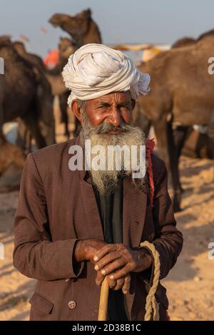 Portrait of an old Indian man wearing a turban and long grey beard at Pushkar, Rajasthan, India on 19 November 2018 Stock Photo