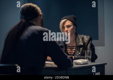 cute drug dealer being questioned at police station. Stock Photo