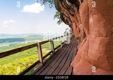 Beautiful Wooden bridge in red cliffside at Wat Phu tok mountain. Bueng Kan, Thailand Stock Photo