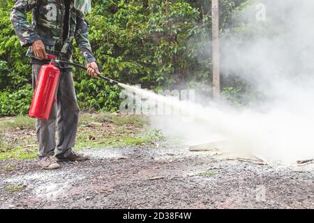A man demonstrating how to use a fire extinguisher Stock Photo