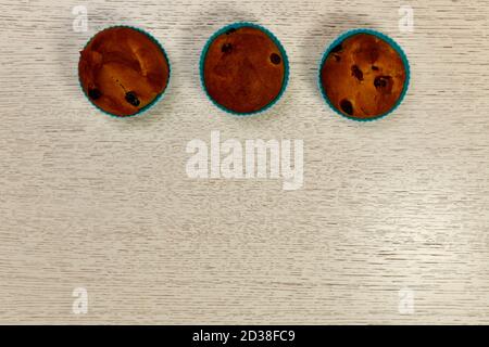 Three ruddy baked Easter cakes, muffins with raisins. In a horizontal row up frame.  Stock Photo