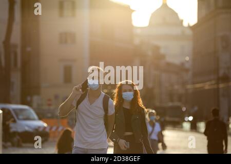 Beijing, Italy. 6th Oct, 2020. People wearing face masks walk at Piazza Venezia in Rome, Italy, Oct. 6, 2020. Credit: Cheng Tingting/Xinhua/Alamy Live News Stock Photo