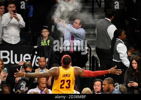 Cleveland Cavaliers forward LeBron James (23) throws powder in the air just before the start of the game against the Brooklyn Nets at Barclays Center Stock Photo