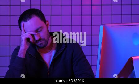 Bearded programmer hacker waiting for program to process. Tired Stock Photo