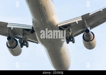 Airplane flight over, landing gear and engines view Stock Photo