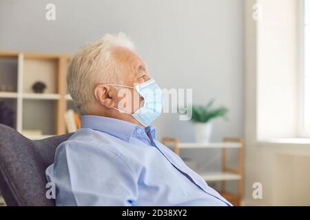 Serious senior man wearing medical face mask which has become must-have accessory Stock Photo