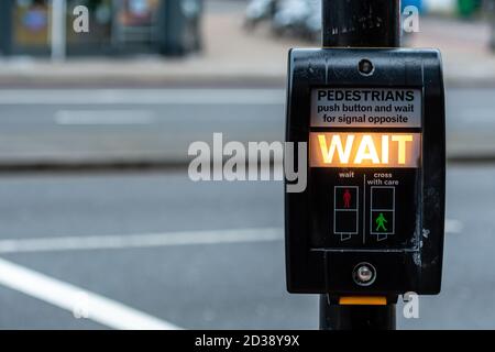 Crosswalk button for pedestrian with light warning on a defocused background , London, UK - image Stock Photo