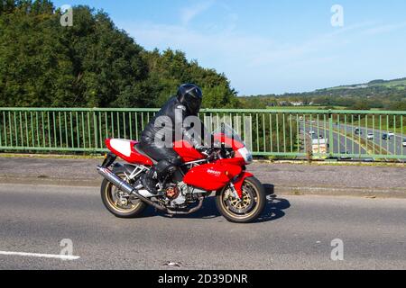 2005 red Ducati 900 Super Sport Motorbike rider; two-wheeled transport, motorcycles, vehicle, roads, motorbikes, bike riders motoring in Chorley, UK Stock Photo