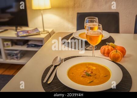 Pumpkin soup and potato with rosemary and bacon is a perfect autumnal recipe or meal for halloween served with a glass of beer Stock Photo