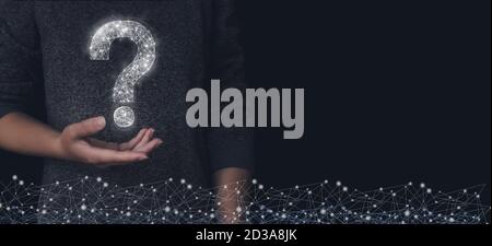 Cropped view of woman hand demonstrating low poly drawing of question mark on dark. Black background. Soft focus. Stock Photo