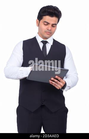 Smiling young businessman using digital tablet on white background Stock Photo