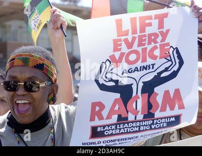 A protestor holds a poster during the second day of the World Conference Against Racism (WCAR) in the coastal city of Durban September 1, 2001. Around 3,000 protesters began a march to the Durban conference centre on Saturday to demonstrate against racism and poverty. REUTERS/Juda Ngwenya  JN/AA