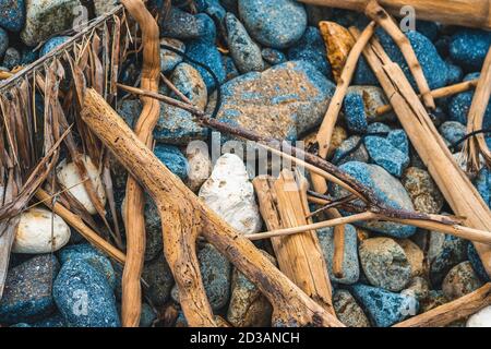 Small and big pebbles, multicolour gray gravel, dry sea thrown brown sticks on stones. Abstract Composition Textured background. Ideal for web banner Stock Photo