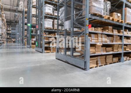 blurred background image of Rows of shelves with goods boxes in modern industry warehouse store at factory warehouse storage Stock Photo