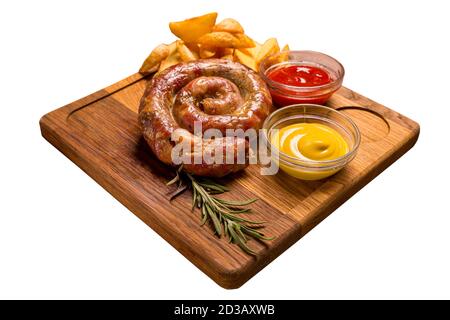 Grilled sausages with french fries with ketchup and mustard on a wooden stand Stock Photo