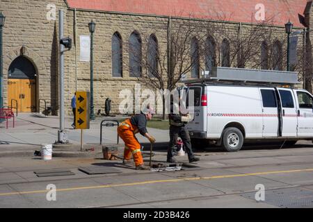 City of Calgary Workers repair the track on 7th Avenue in downtown Calgary, April 23rd, 2018. Stock Photo