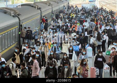 Yantai, China's Shandong Province. 8th Oct, 2020. Passengers get off a train at Yantai Railway Station in Yantai, east China's Shandong Province, Oct. 8, 2020. Transportation hubs in China are witnessing the peak of return passengers as the eight-day holiday ends on Thursday. China celebrates its National Day on Oct. 1, and the weeklong holiday this year has been extended to Oct. 8 as it overlapped with the Mid-Autumn Festival, a traditional festival symbolizing family reunion that falls on Aug. 15 on the lunar calendar. Credit: Tang Ke/Xinhua/Alamy Live News Stock Photo