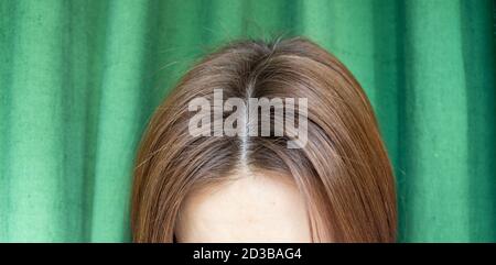 Women's hair after washing on a green background.the view from the top Stock Photo