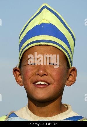 A young Mongolian jockey is seen before a horserace during the Naadam Festival at Khui Doloon Khudag village, some 35 kms (22 miles) outside the Mongolian capital Ulan Bator July 12, 2003. About 400 horses, ridden by young jockeys, boys and girls aged between five and 13 years old, competed in the 22 kms race. Naadam is the biggest event in the Mongolian calendar held on July 11 to 13, marking the anniversary of the Mongolian revolution of 1921.