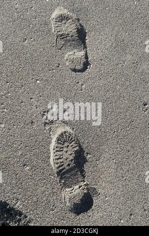 Shoe footprint imprints on a sandy beach Stock Photo