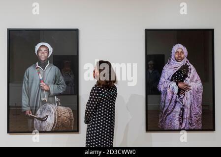 London, UK.  8 October 2020. A staff member views 'Khamlia, Southern Morocco #2', 2014, and 'Khamlia, Southern Morocco #1', 2014, both by Leila Alaoui.  Preview of Leila Alaoui: Rite of Passage at Somerset House. The exhibition is the first major UK retrospective of works by the celebrated late French-Moroccan photographer, video artist and activist who was killed aged 33 after suffering injuries during a terrorist attack in Burkina Faso whilst on a photographic assignment for Amnesty International.  The exhibition runs 11 October 2020 – 28 February 2021.  Credit: Stephen Chung / Alamy Live Ne Stock Photo