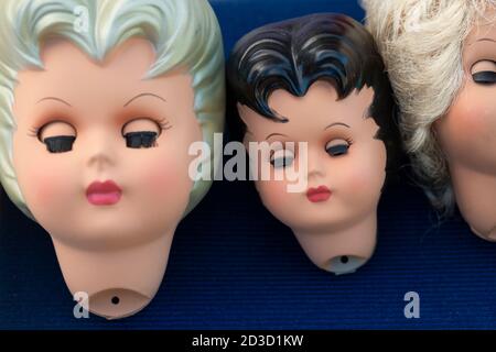 Head of Three Plastic Dolls With Closed Eyes Stock Photo