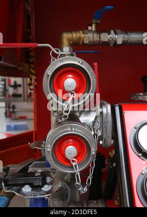 Cracow. Krakow. Poland. Fire engine water pump hose connectors closed with the red plugs. Stock Photo